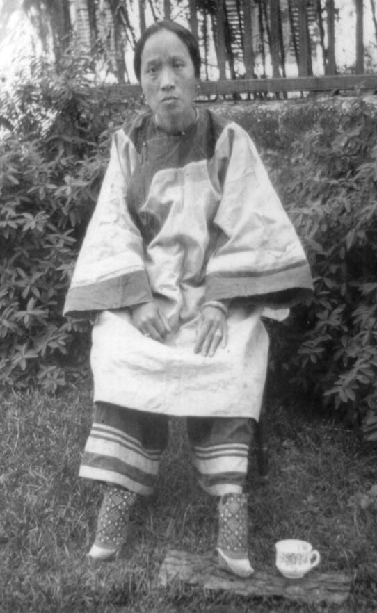 Chinese woman with small bound feet and leggings that are worn under her main, baggy trousers (c. 1905; courtesy of the Library of Congress, LC-USZ62-80735).