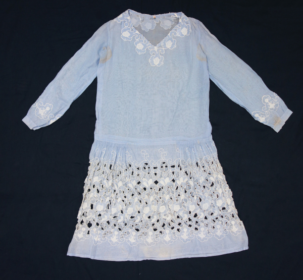Dress made of a powder blue cotton material and decorated with cutwork and abstract organic shapes, all in white.  The Netherlands, 1920s.