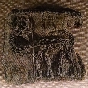 This piece of embroidery depicts a stag turning its head. It is carried out in the couching technique. A grave find from Bj&ouml;rk&ouml; (Birka), Adels&ouml;, Uppland, Sweden.