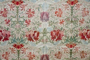 Detail of a silk and linen hanging (267 x 150 cm) decorated with a honeysuckle motif, designed by William Morris in 1876, and embroidered by Jane and their daughter Jenny Morris, c. 1880's. This piece was displayed at the 1914 Louvre exhibition of British and Irish decorative needlework.