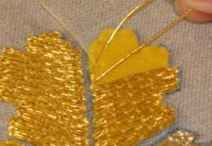 Goldthread being passed over the template.