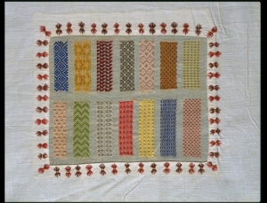 Long sampler of needlework, with a series of sampler panels. The cotton panels contain samples of plain sewing. 