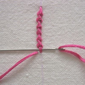 Creating a Smyrna stitch.