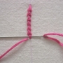 Creating a Smyrna stitch.