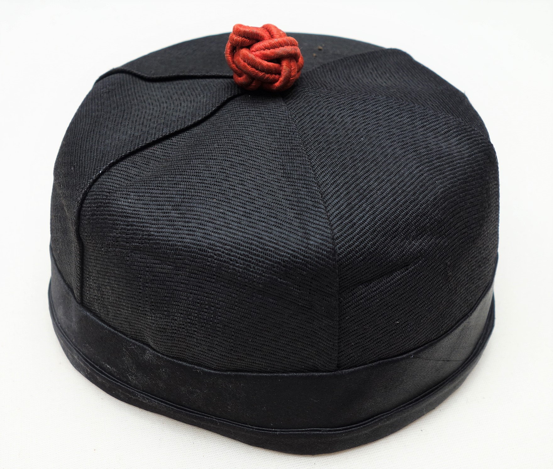Cap with red knot on top, China, early 20th century (TRC 2004.0087).