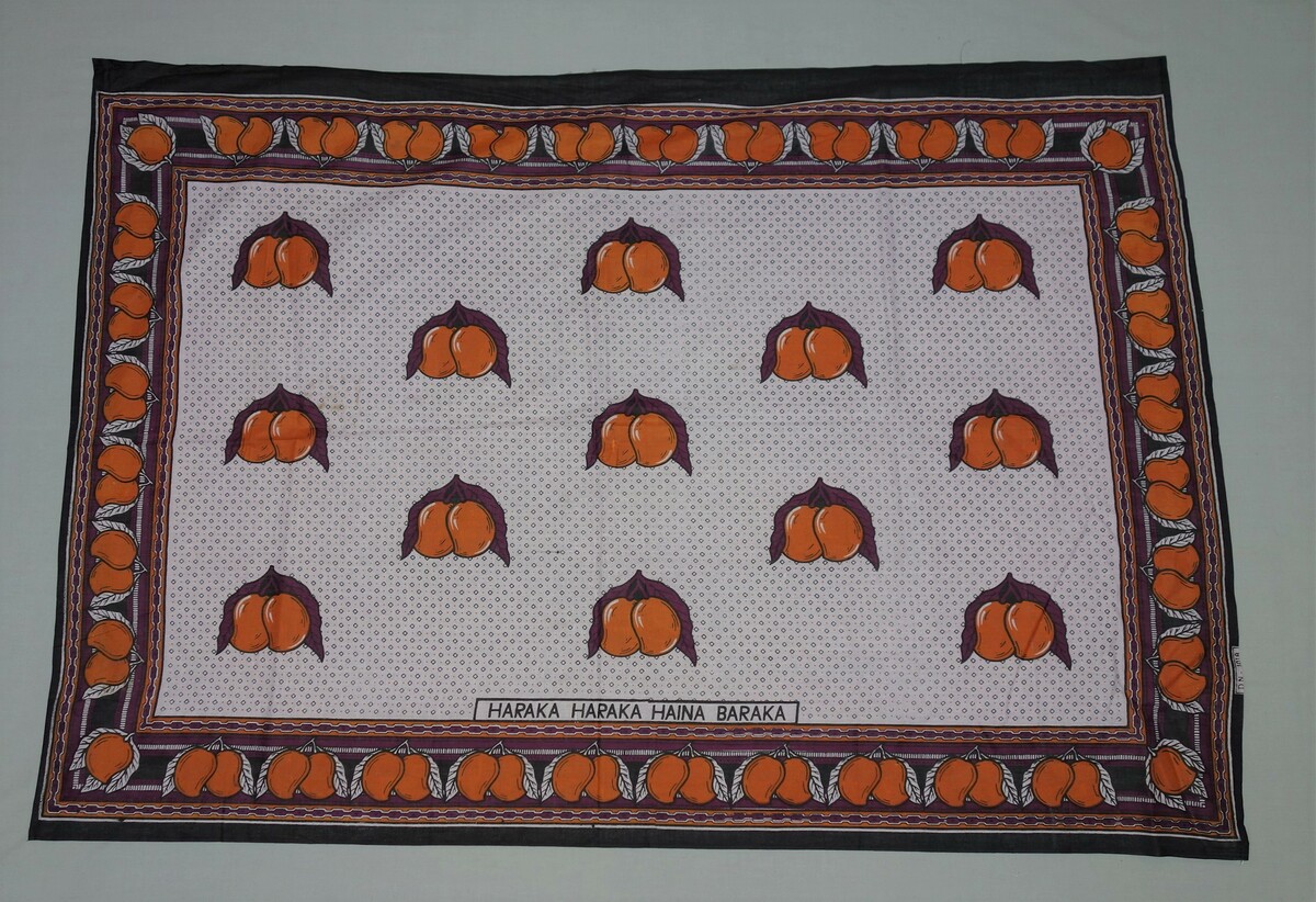 Kanga from Ibra in Oman, 1995, with the text: "Haraka haraka haina baraka" ('Hurry hurry has no blessing') (TRC 2005.0219). Kangas are also worn in Oman, reflecting the historical relations between East Africa (and in particular the island of Zanzibar), and Oman.