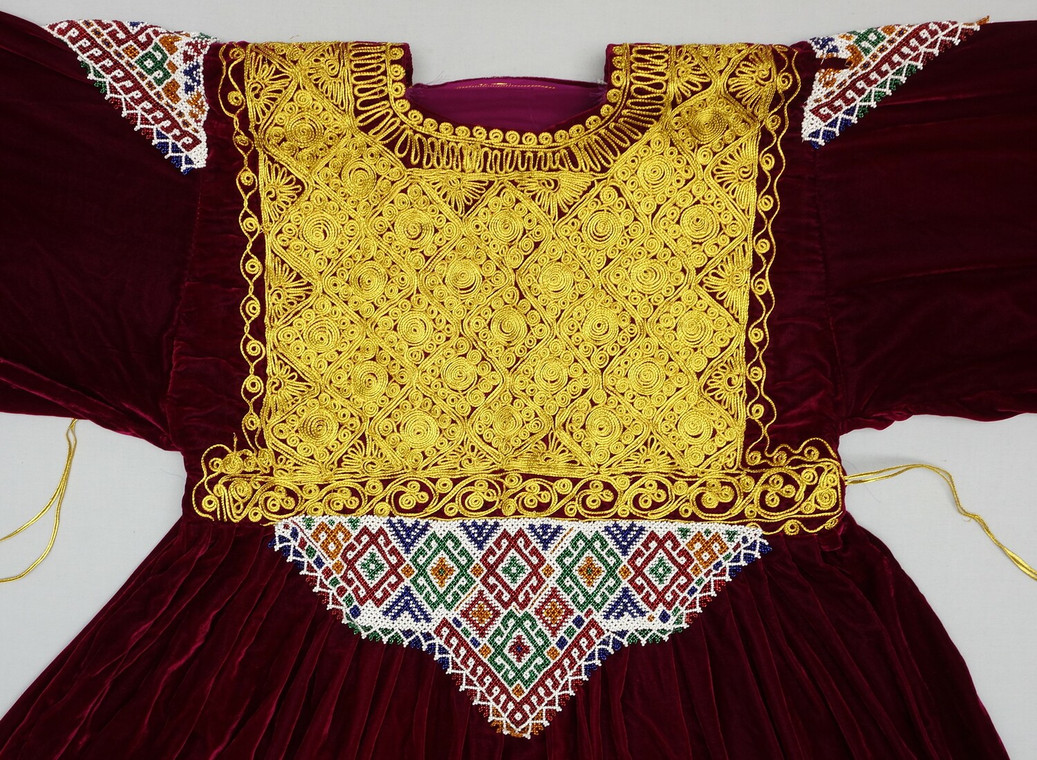 A detail of an Afghan/Pashtun bridal dress in velvet, with extensive gold thread embroidery, 2004 (TRC 2005.0251b).