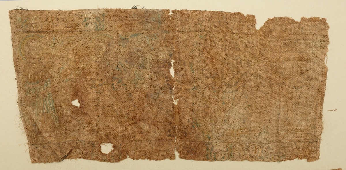 Fragment of a linen, Coptic textile, with inked designs of saints, some of which with extant silk embroidry threads. 6th-8th c (TRC 2011.0462).