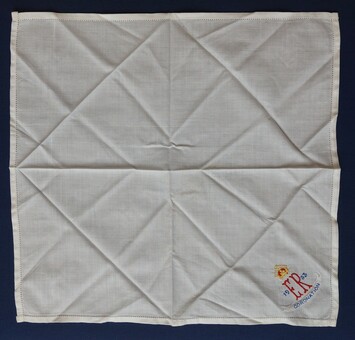 White handkerchief with a crown and "ER 1953 Coronation" in hand embroidery (TRC 2019.1440).