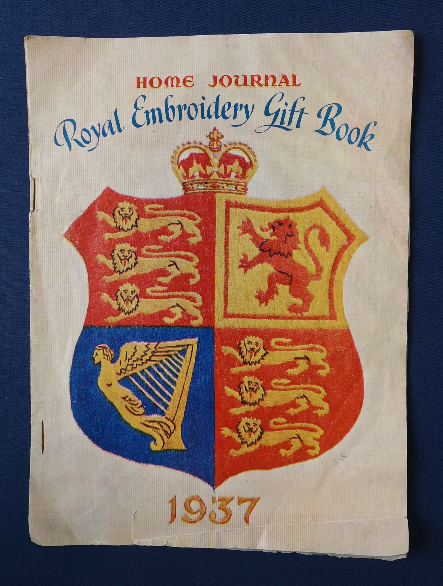 Booklet entitled "Home Journal Royal Embroidery Gift Book 1937", with transfers for the coronation of King George VI in 1937 (TRC 2019.1441).