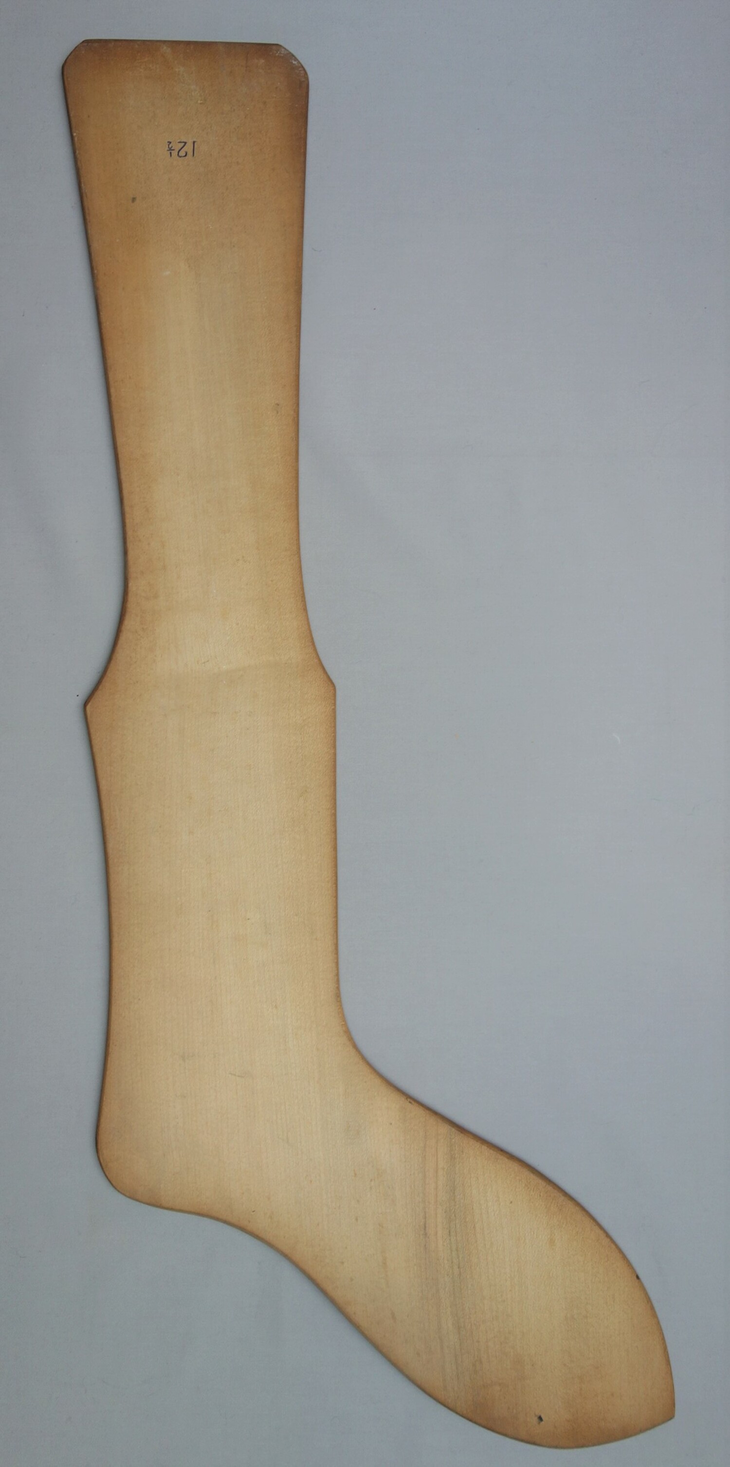 A wooden sock form (TRC 2020.0145).