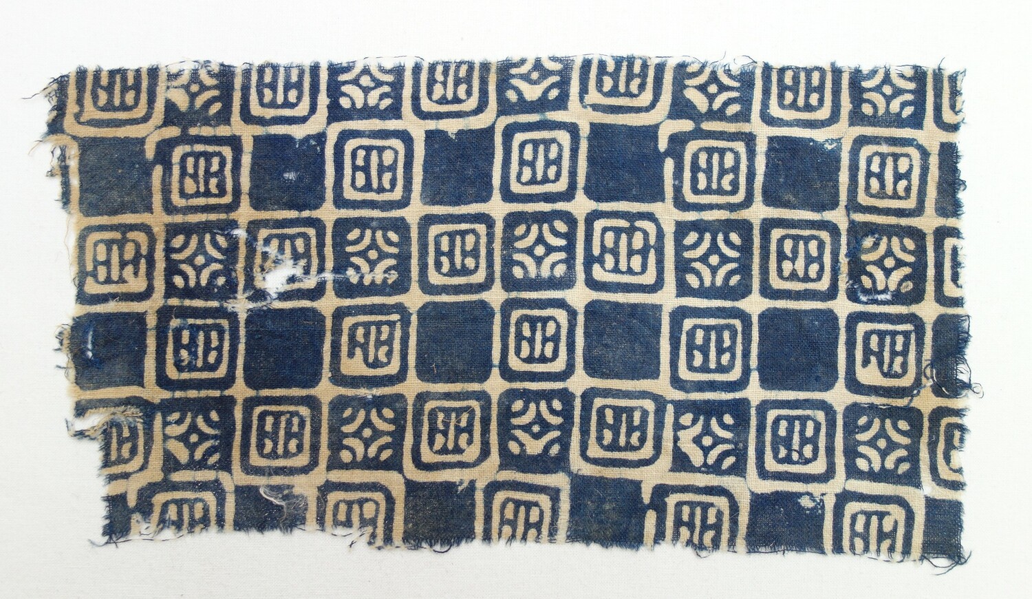 Fragment of a block printed 14th century Indian textile produced with a resist technique. The textile came from the 1980 excavations at Quseir al-Qadim, Egypt (TRC 2020.0237).