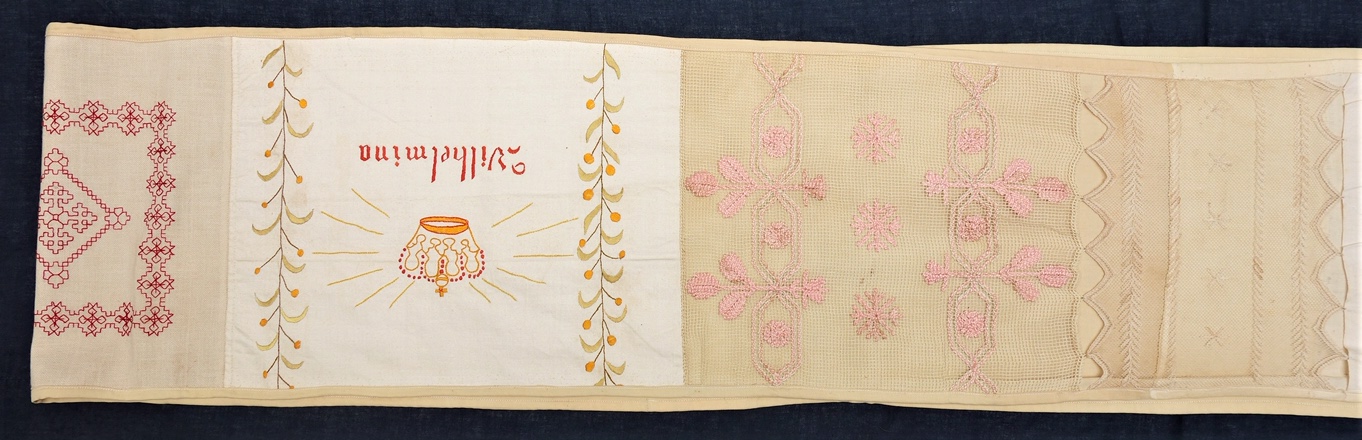 Detail of a Dutch 'pronkstuk' needlework sampler (592 x 26 cm), made by Anna Berendina Bennink in 1905-1906 (TRC 2020.3535a). The name of Wilhelmina is that of the Queen of The Netherlands from 1898-1948.
