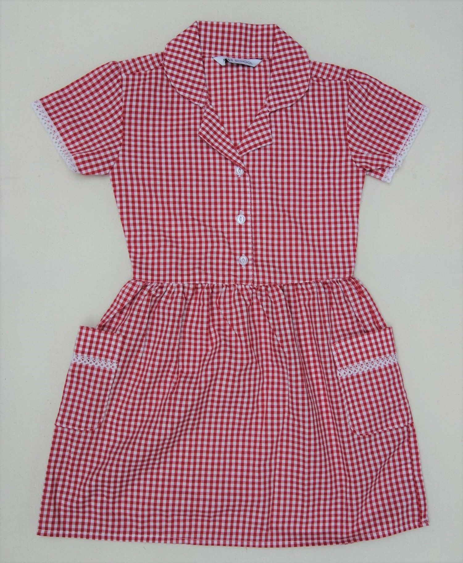 A 2020 Burton Leonard summer school uniform dress in red and white gingham (TRC 2020.3704).