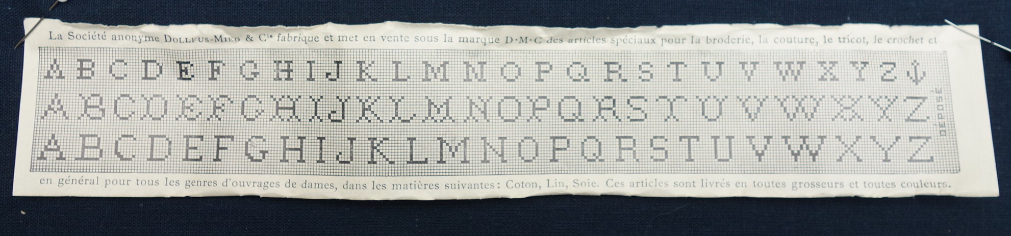 Embroidery pattern sheet with three alphabets that was tucked inside a ball of thread, DMC, France, 1920's-1930's (TRC 2021.0775i).