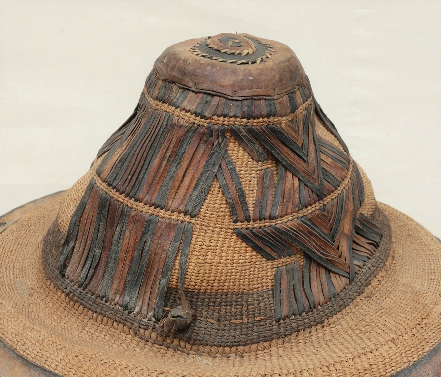Detail of straw and leather hat from western Africa (TRC 2021.1962).