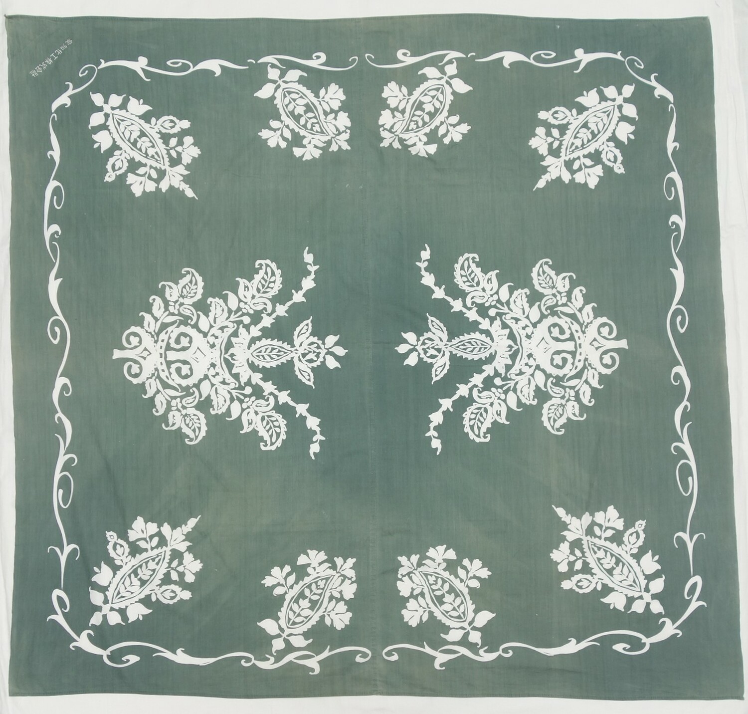 Japanese wrapping cloth (furoshiki) with a white pattern of ornate scrolls and Paisley (buteh) motifs. Japan, mid-20th century (TRC 2021.2150).