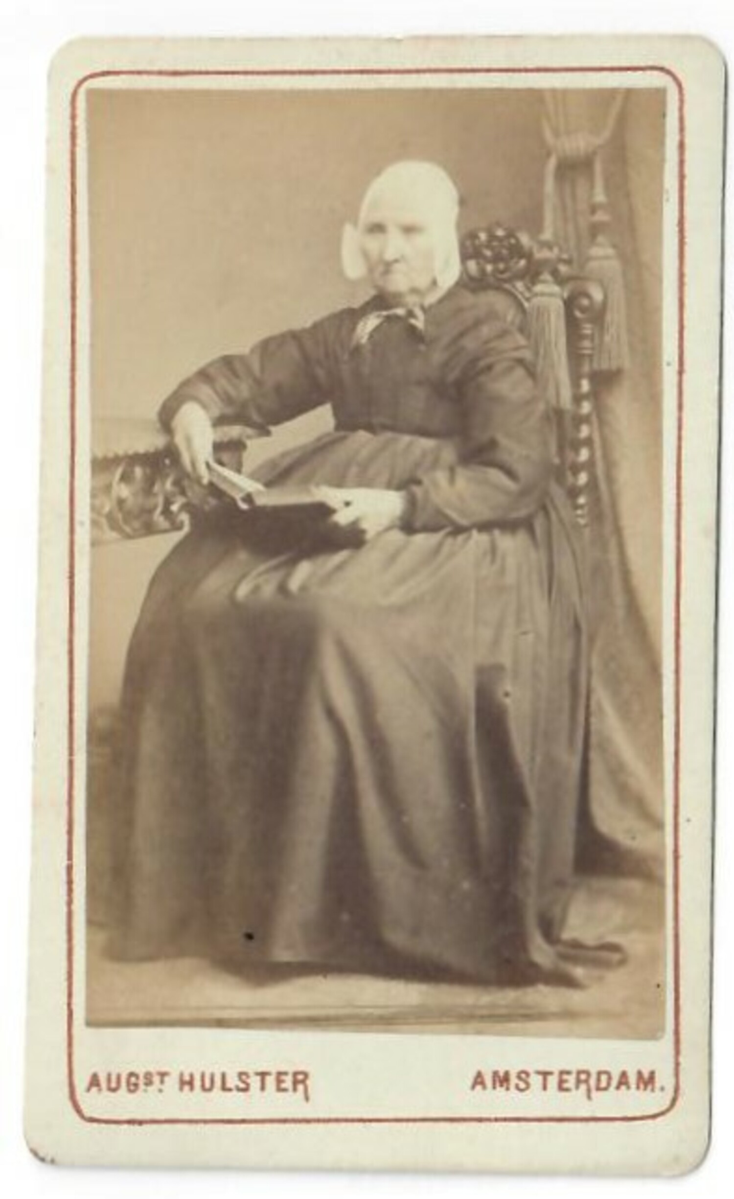 Photograph of a seated woman wearing a short Rijnland cap, 1860s-1870s. Photographer: August Hülster, Amsterdam (TRC 2021.2439s).