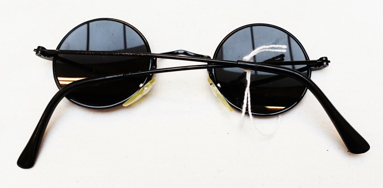 Fig. 5. Pair of sun glasses with round, metal frames and spring temples. The Netherlands, 1920s (TRC 2022.3075).