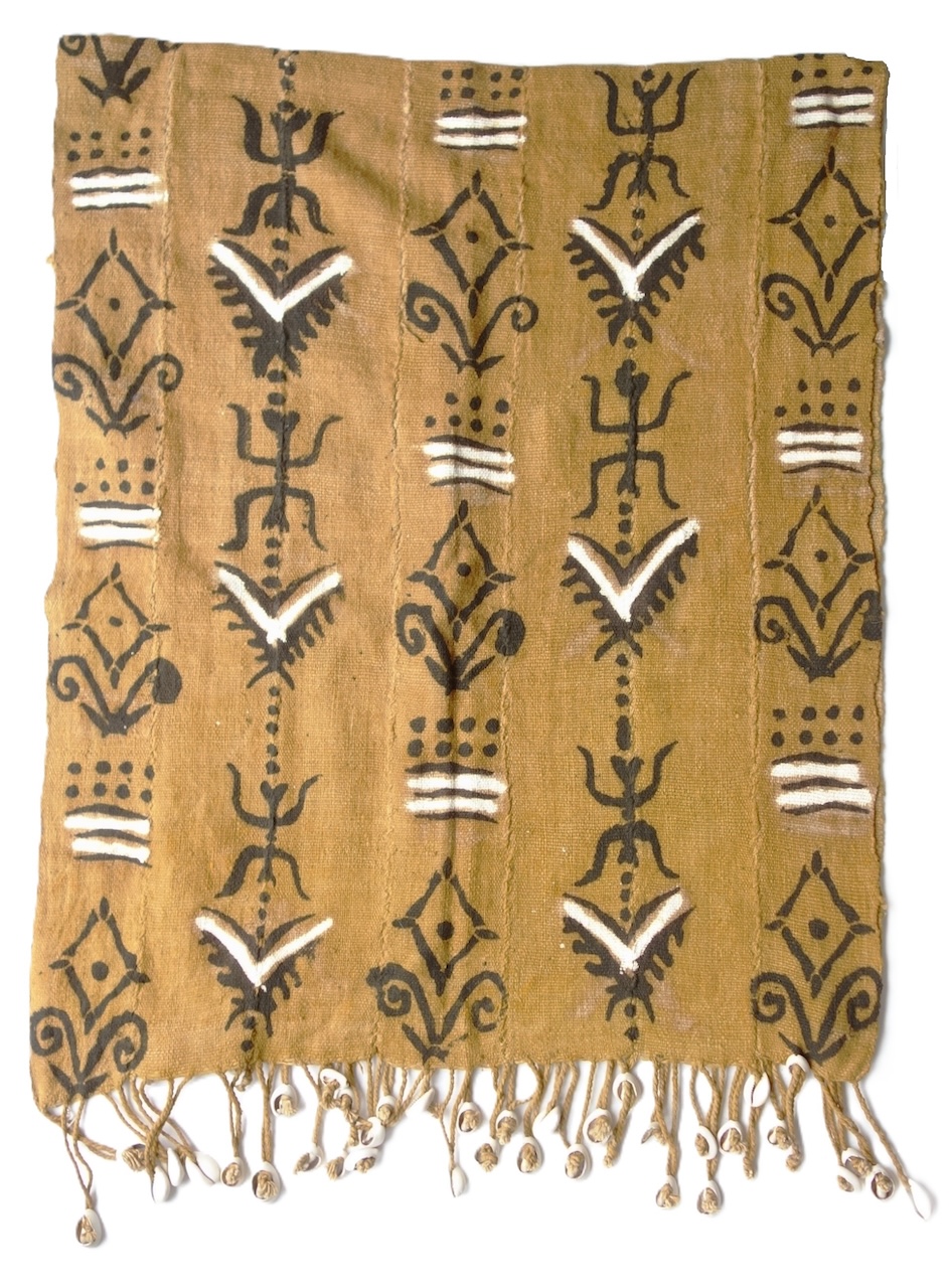 A recent acquisition: Length of cloth made from strips (15 cm) of woven cotton, which has been dyed brown and then painted with diamonds, wavy lines, stylised plants, lines and dots in black and white on a brown ground. The fringes are decorated with white cowrie shells. Mali? (TRC 2026.2254).