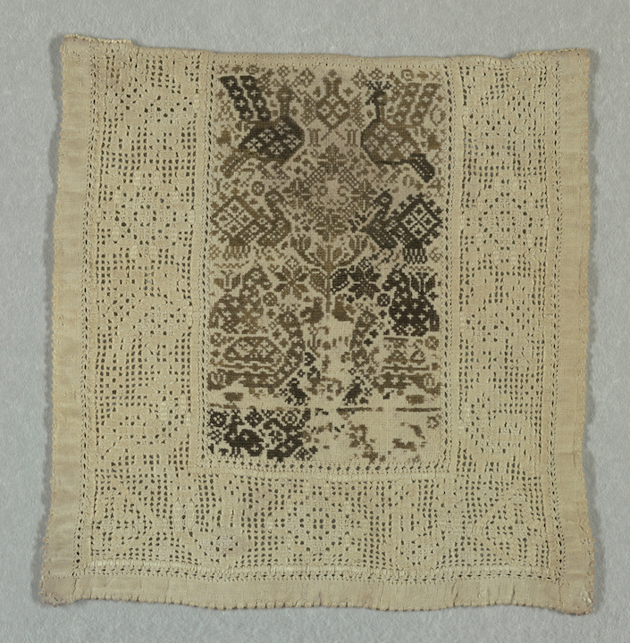 An embroidered panel with a cross stitch centre and a drawn thread work border (1794, Amager, Denmark; bequest of Mrs. Henry E. Coe, courtesy of the Cooper-Hewett Museum, New York 1941-69-116).