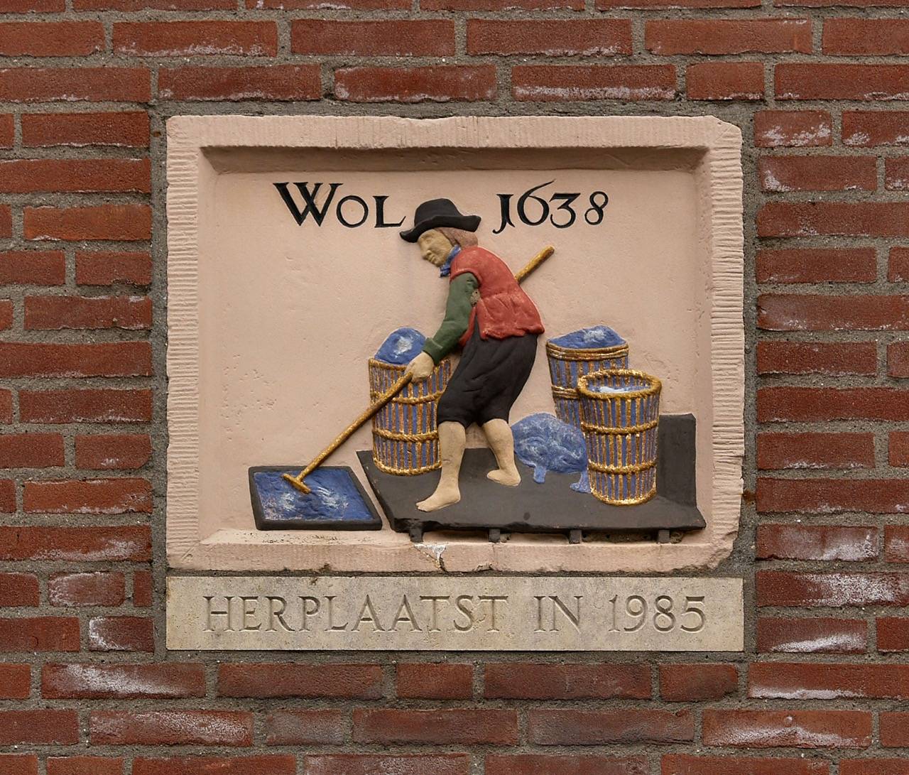Gable stone in Leiden, dated 1638, depicting a man working (dyeing or washing?) blue dyed cloth.