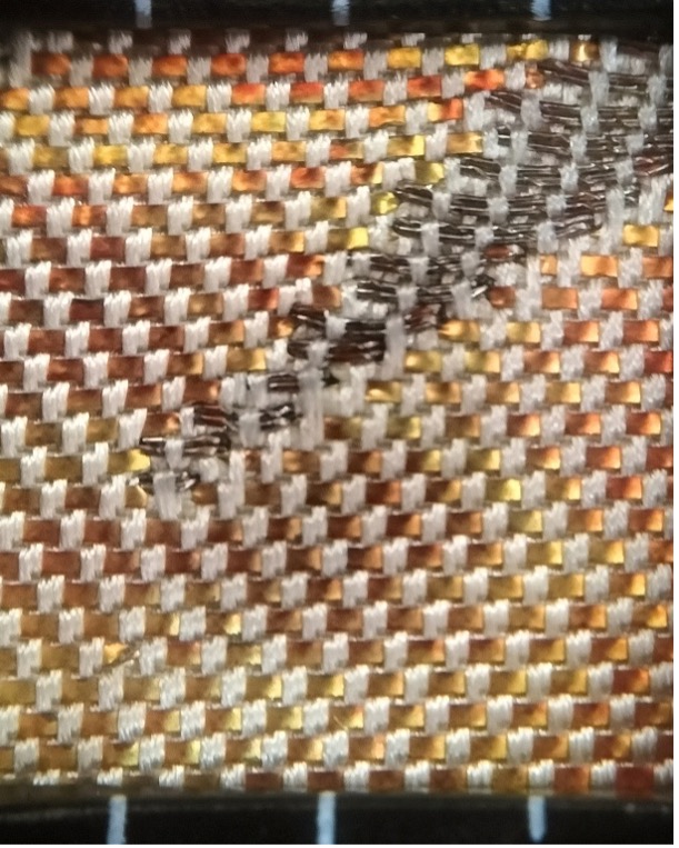 Fig. 4. The structure of a hikibaku weave. The weft threads are in silver-grey, the hikibaku strips are in yellow-orange-brown, and the warp threads are in a cream colour.