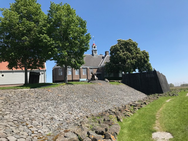 The church of Schokland and the (restored) sea ddefences. Photograph Willem Vogelsang, May 2021.