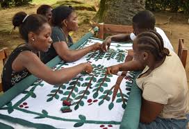 Liberian quilting collective works on a Coffee Tree quilt.