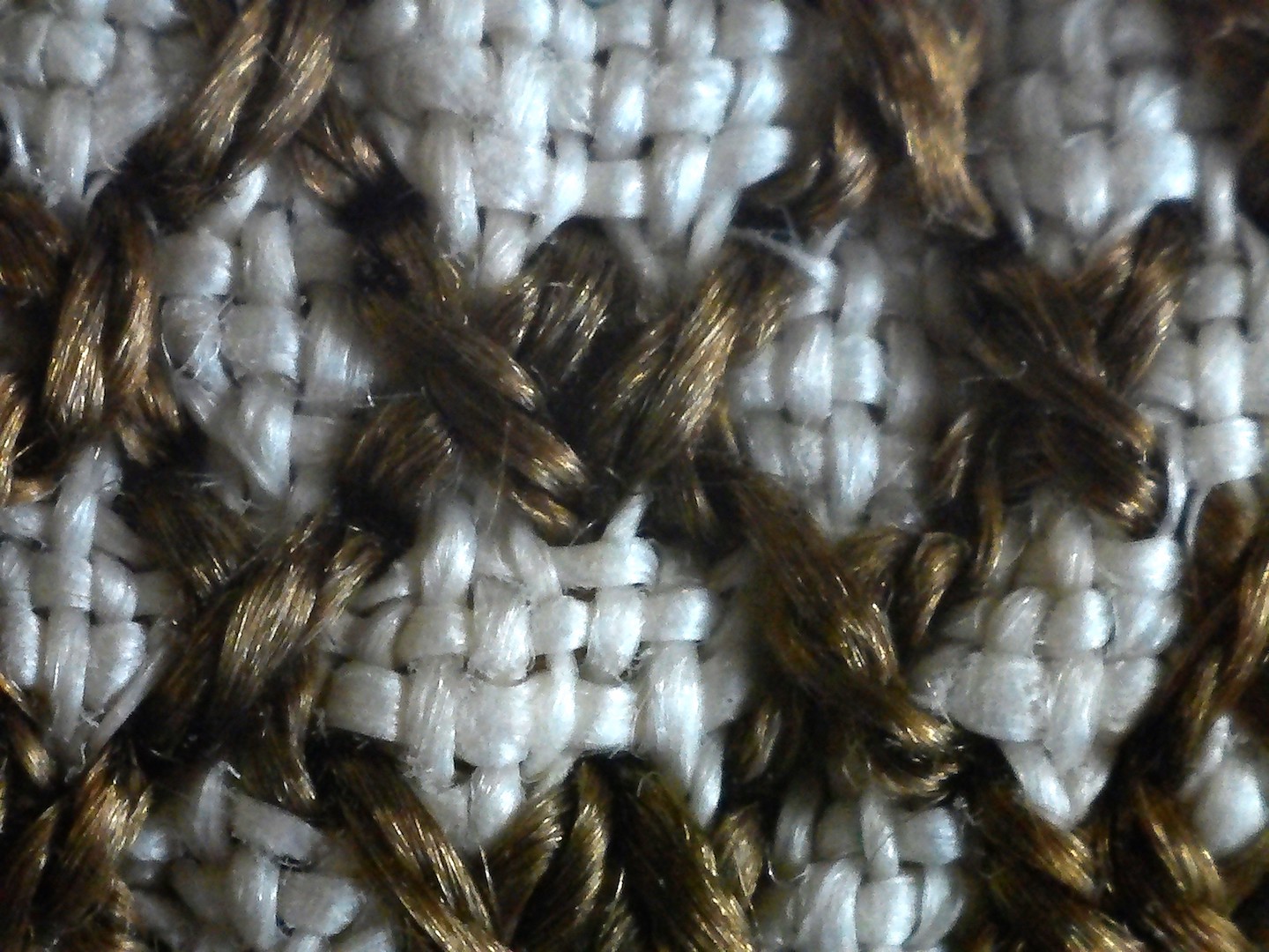 Close-up photograph of the dark brown cross stitches.