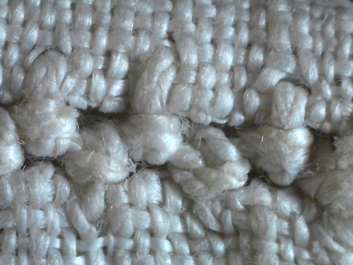 Detail of the faggoting line that joins the two lower edges of the bag together.