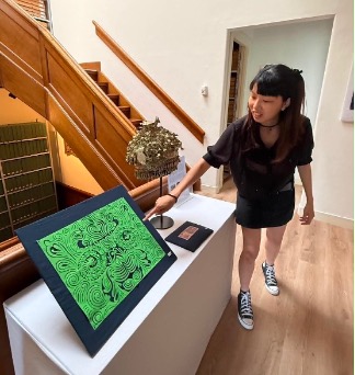 Fig. 8. Visitors exploring the exhibition and learning about Miao textiles through guided tours. Photograph buy author.