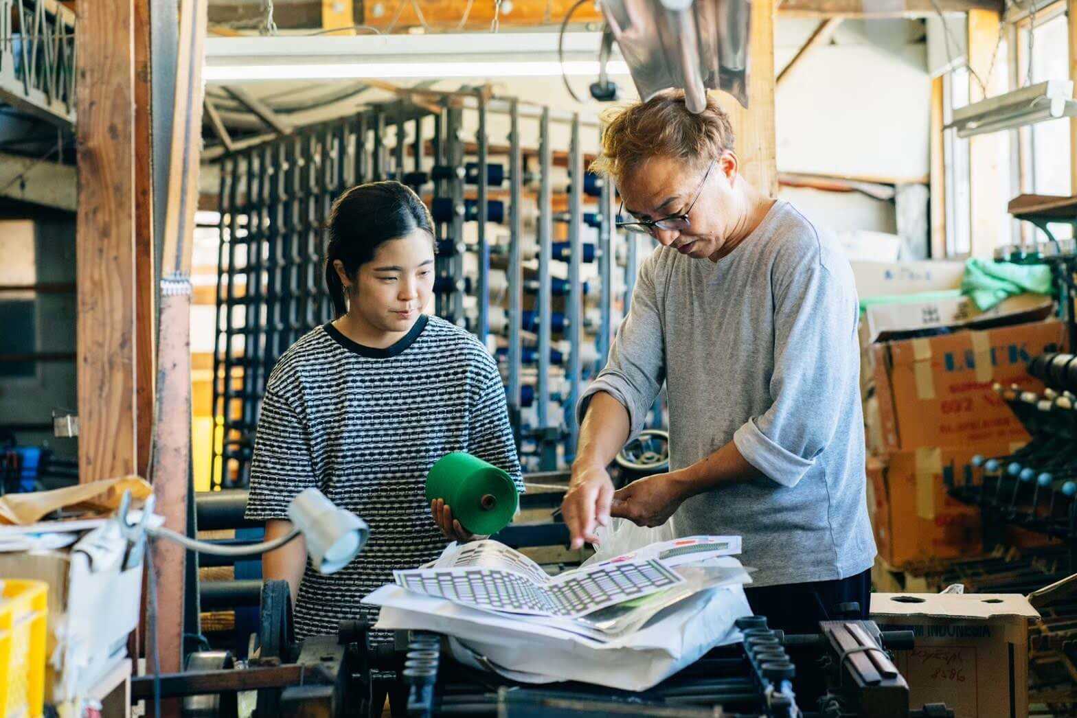 Hana Mitsui stayed at Shimogawa Orimono workshop and experienced the production process of Kurume kasuri fabrics based on her own designs. Here, she is pictured with Kyozo Shimogawa, the third-generation owner of Shimogawa Orimono. Photograph: www.hanatextiledesign.com