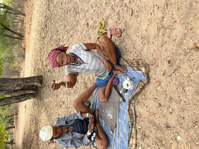 Two women from among the Ju/’hoan San Bushmen in Namibia preparing ostrich shells for making them into jewelry. Photograph by Ann Cable.
