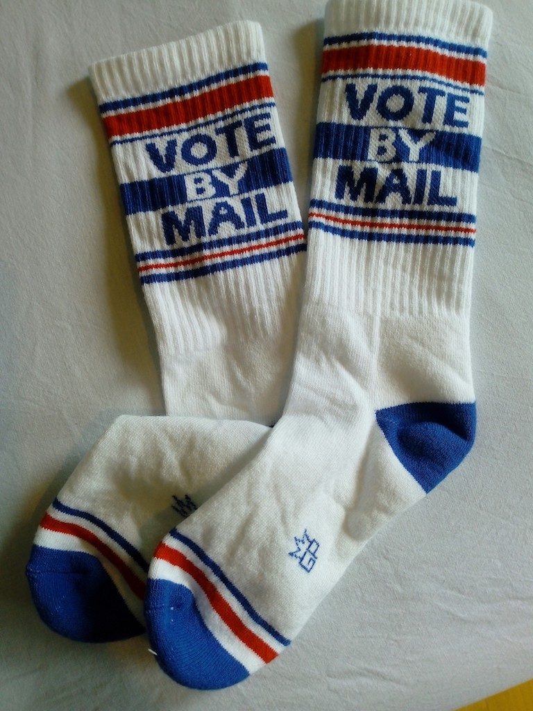 Pair of socks with the text, "Vote by mail", USA, 2020 (TRC 2020.4198a-b).