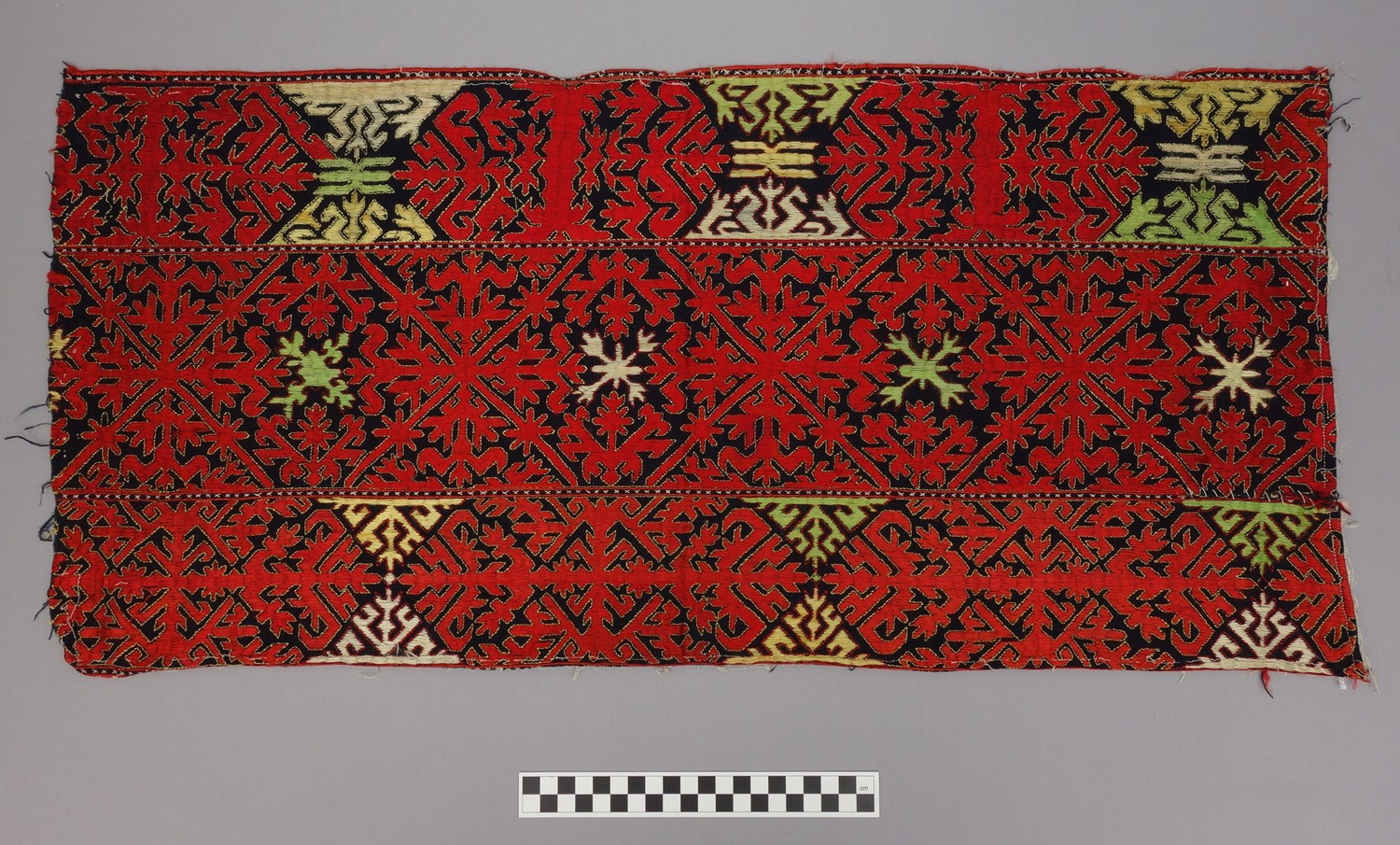 Panel with red, green, and yellow floss silk embroidery, Afghanistan/Pakistan, mid-20th century (TRC 2016.1771).