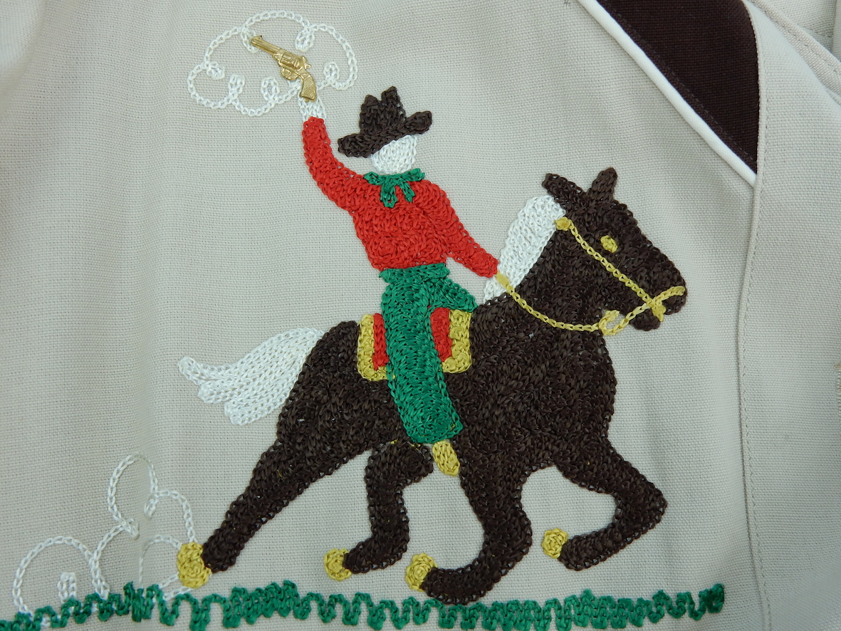 Detail of a cowgirl shirt embroidered with horserider. TRC 2017.0267