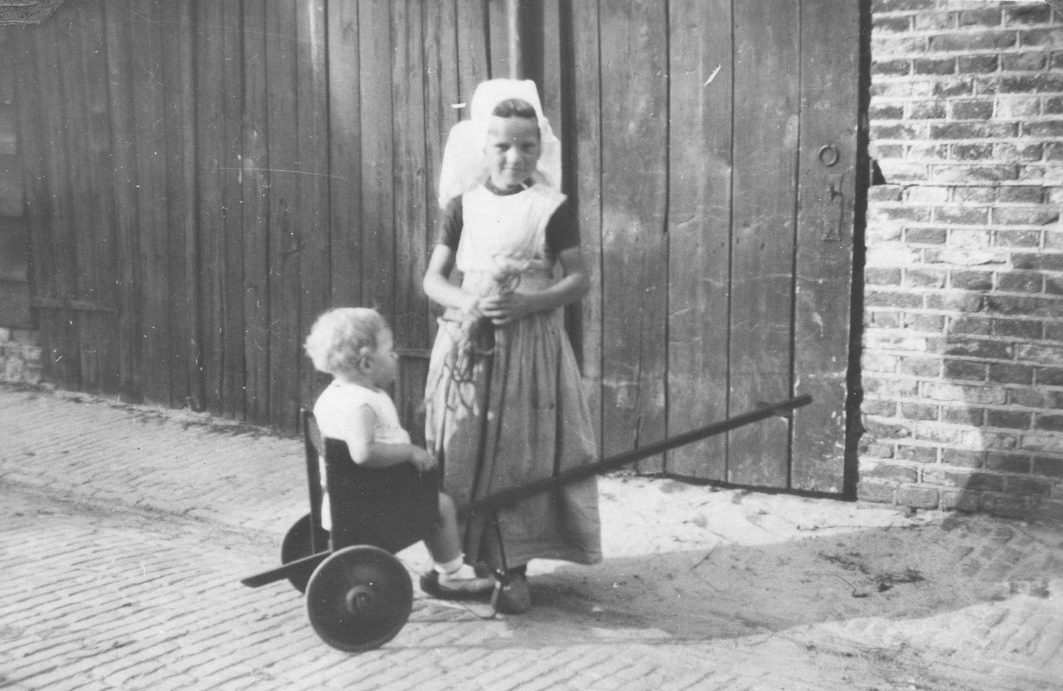 Girl with child from Walcheren in Zeeland, in the southwestern part of the Netherlands, in local costume. Photograph was taken in 1929.