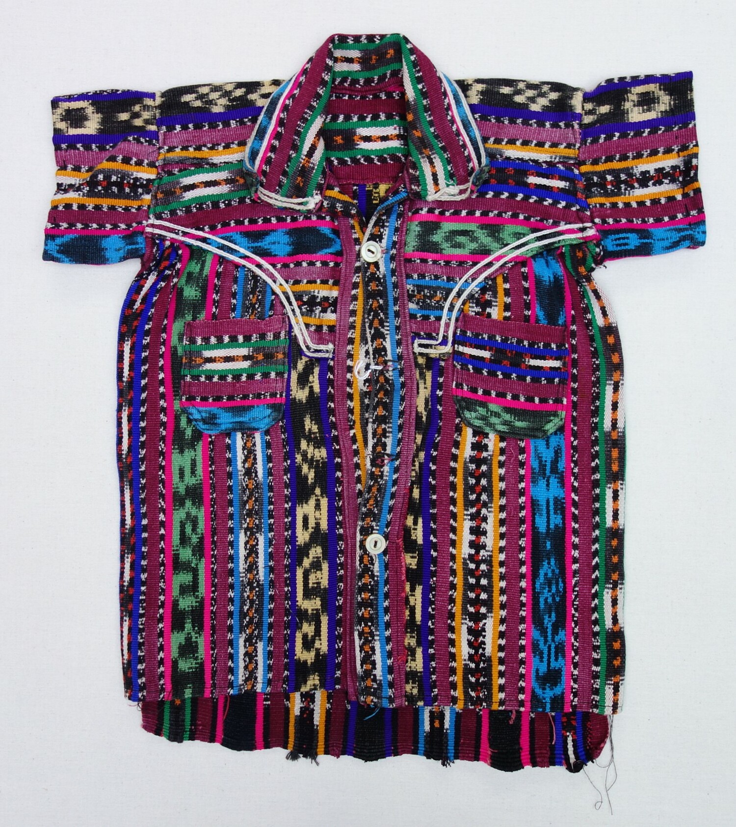 A young boy's shirt from Guatemala, with ikat stripes, late 20th century (TRC 2020.4573).