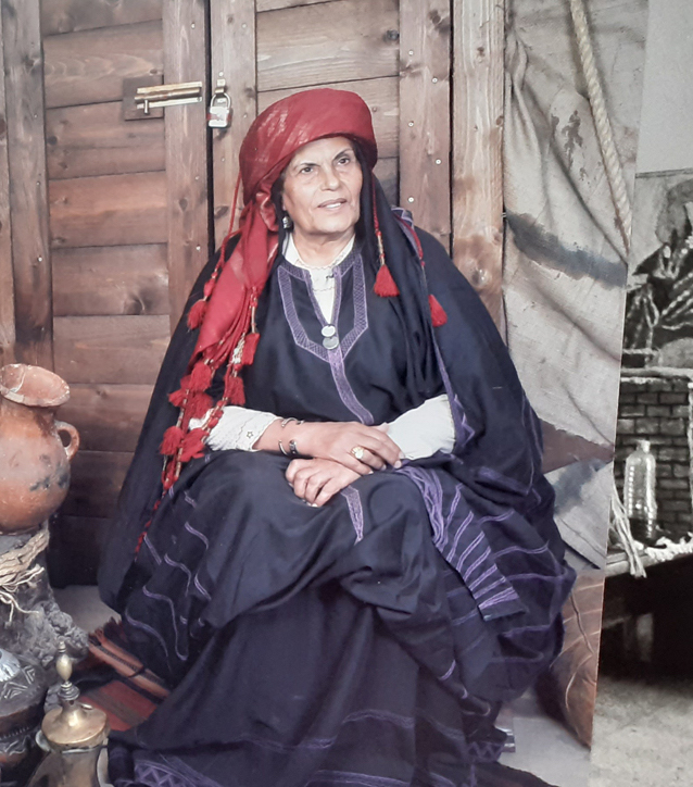 Woman in Al Salt wearing a khalaga dress. Photograph by Fatima Abbadi.