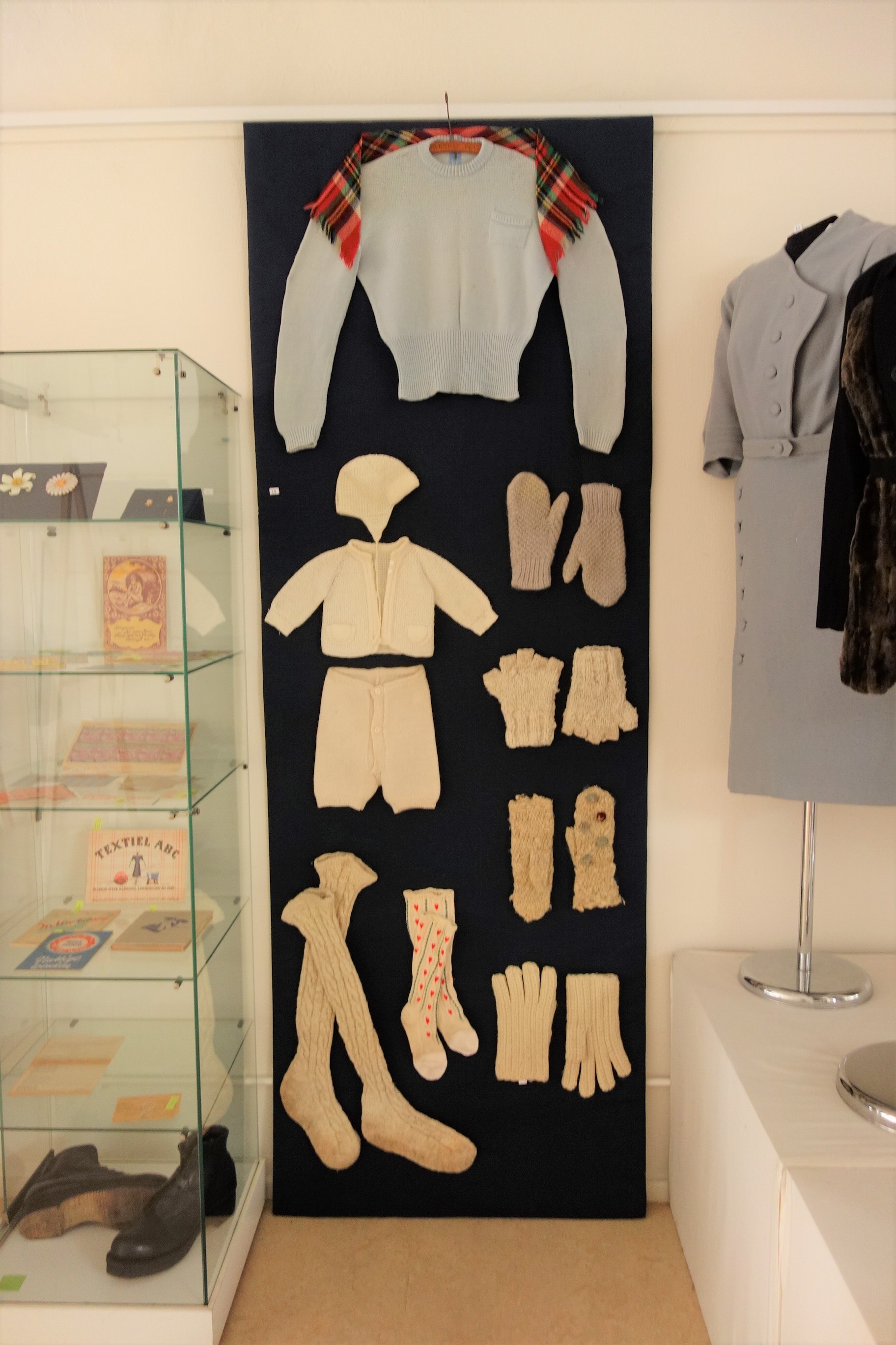 A range of hand knitted garments from the 1940s, some of which were made from hand spun yarn.