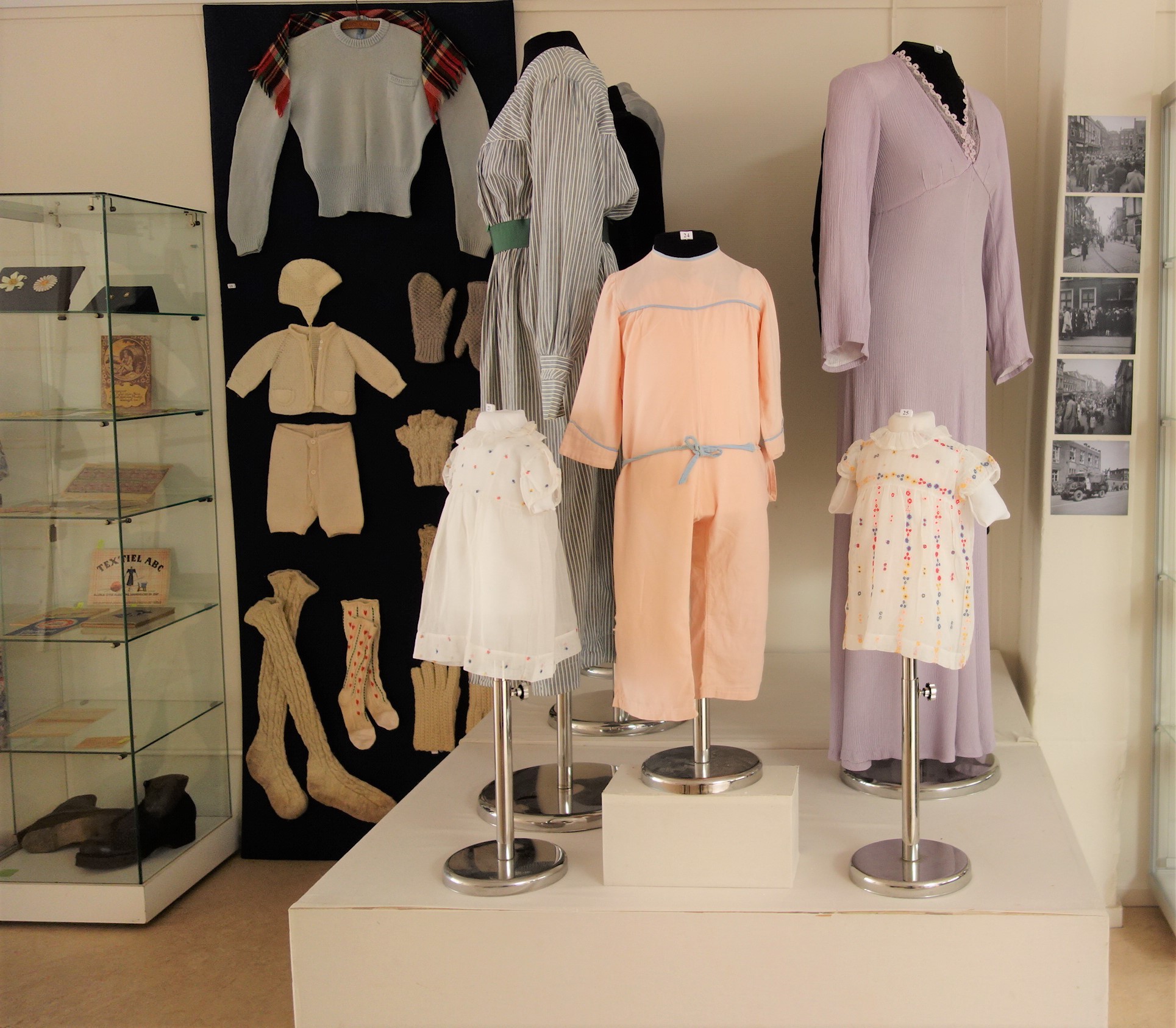 During the Occupation, textiles were rare and garments were mended or made from older garments or bedding. The pink child's garment in the centre is made from an old flannel sheet.